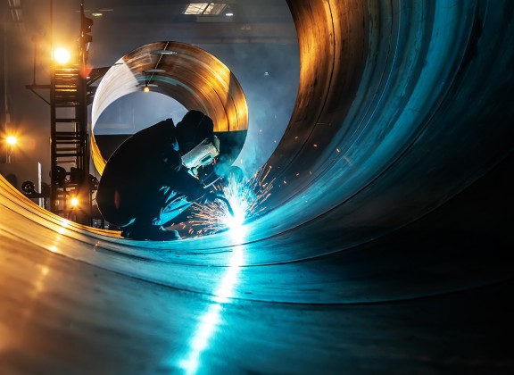 welder working on pipe interior